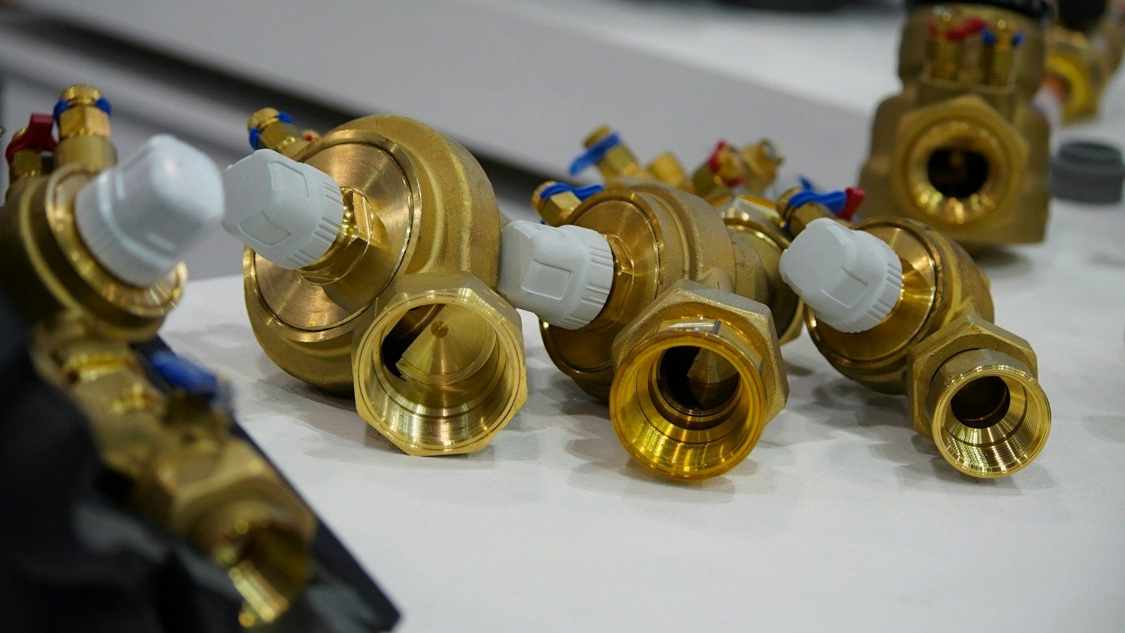 Brass valves laid out on a workbench